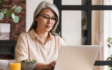 A woman looking at a laptop