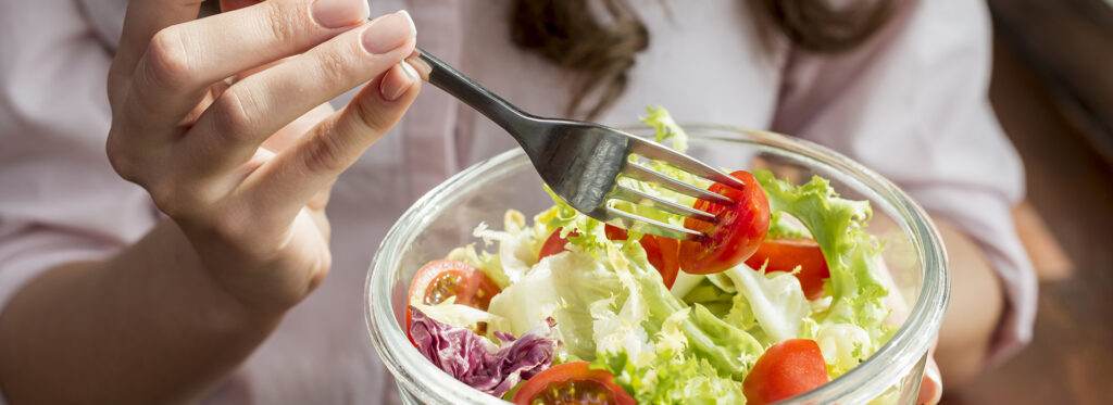 brunette woman eating salad